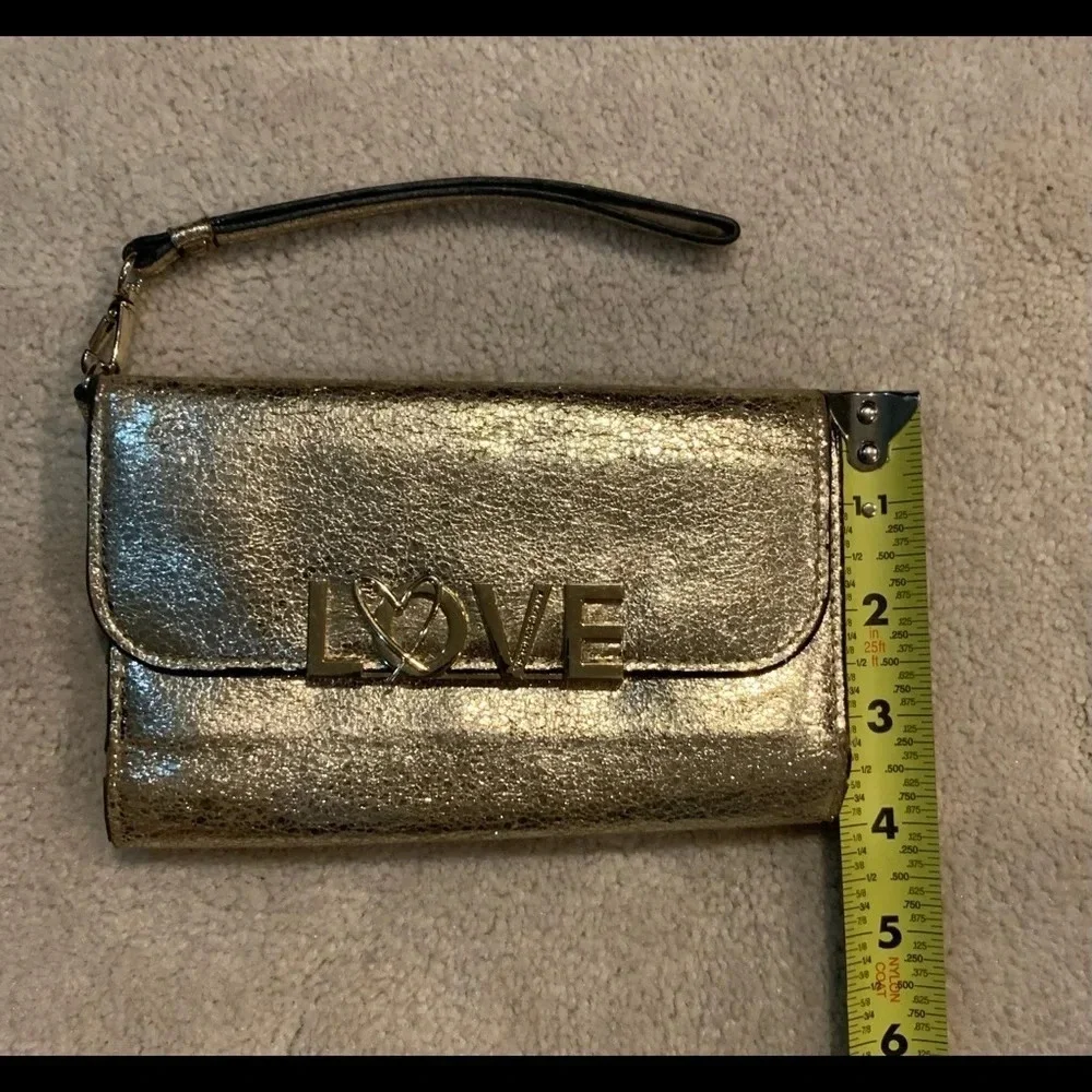 VICTORIA’S Secret shimmer phone wallet, golden